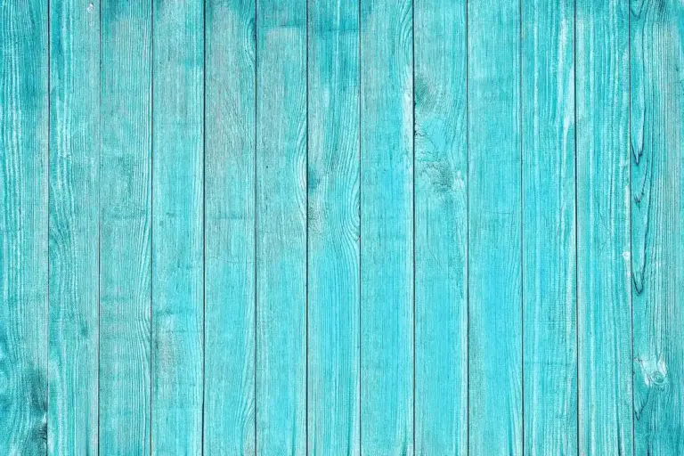 Close-up of vertical blue-painted wooden planks with visible grain patterns