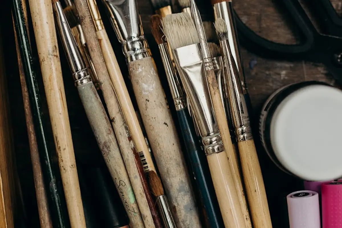Close-up of assorted paintbrushes and painting tools laid out together