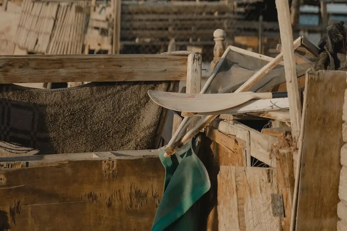 Outdoor workspace with weathered lumber and tools, suggesting material selection for outdoor projects.