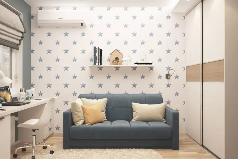 Cozy children's room featuring a blue sofa, star-pattern wallpaper, a white desk and shelving.
