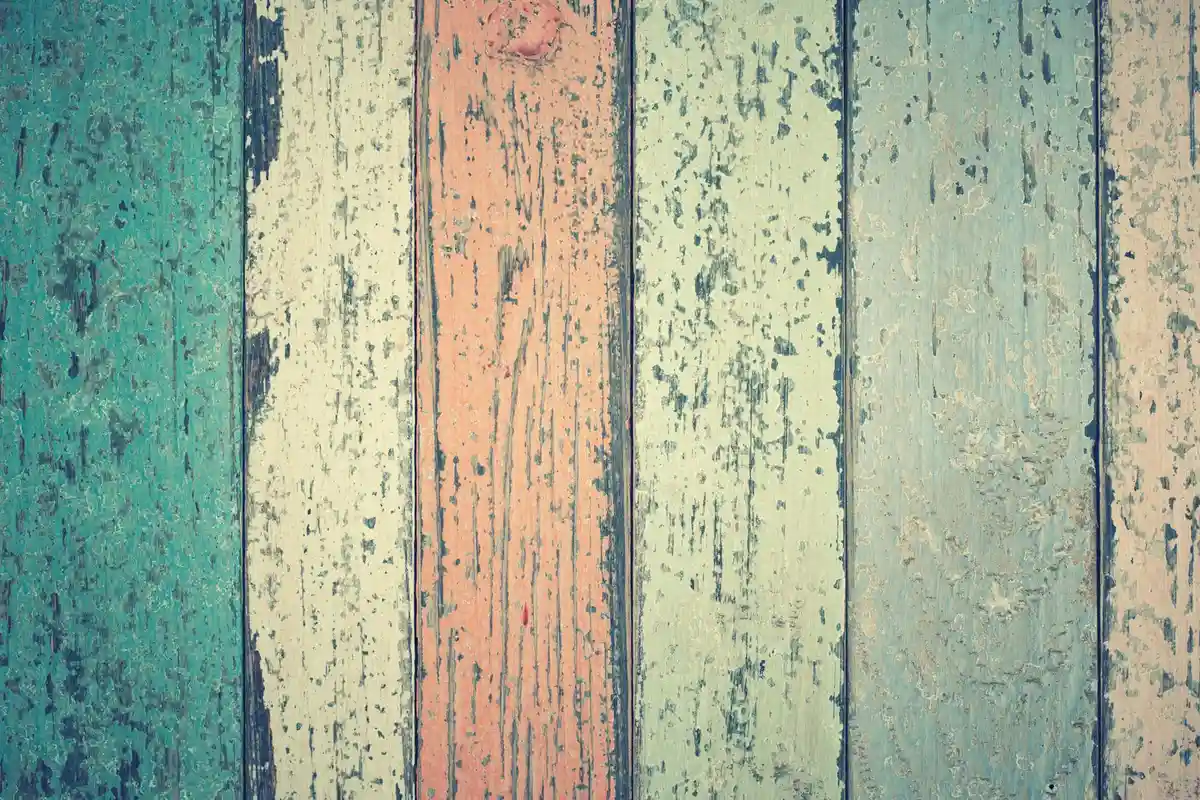 Colorful, weathered wooden boards with visible grain and pores.