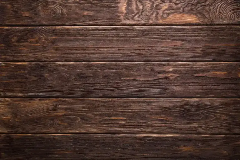 Dark stained wood plank surface with prominent grain and texture