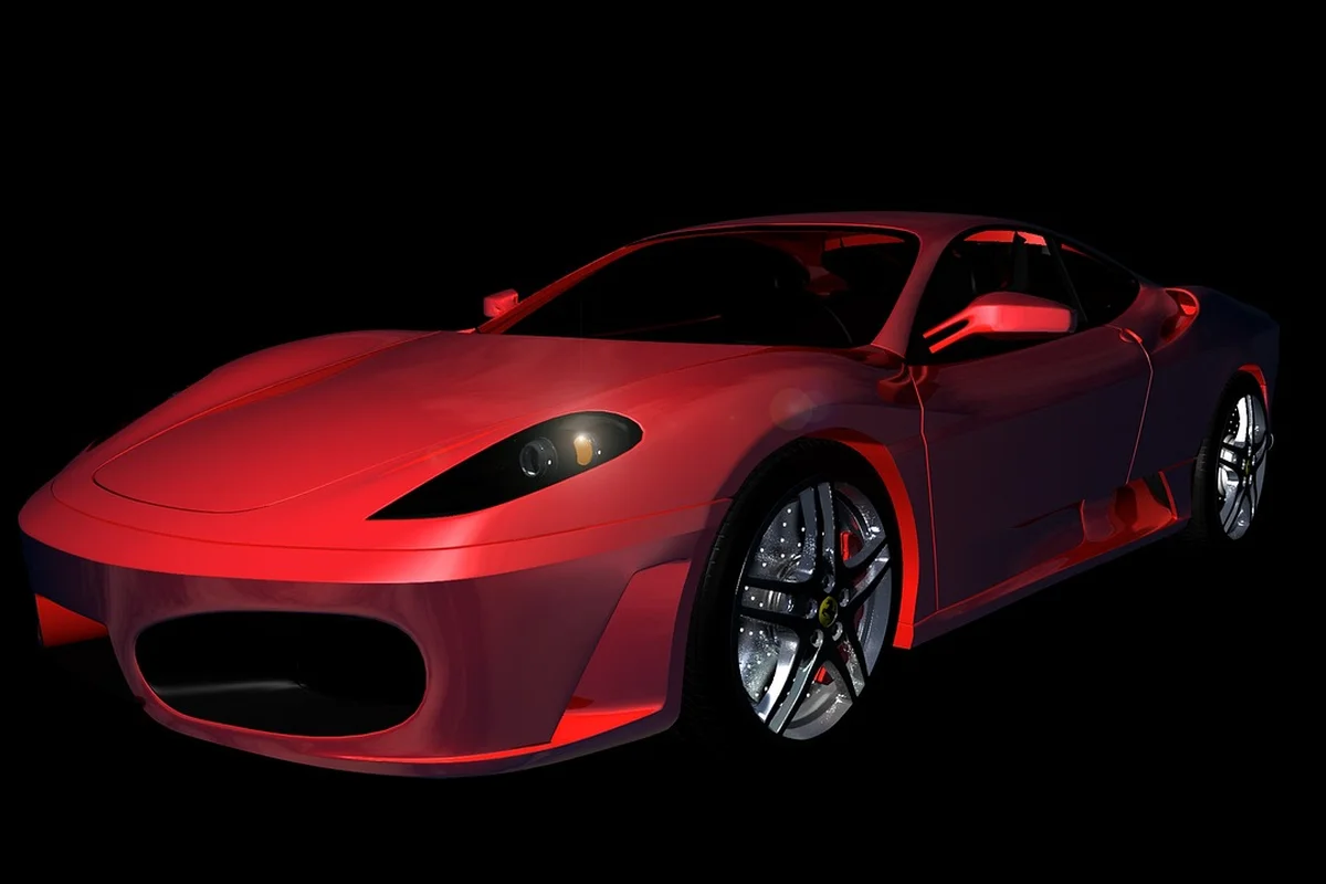 Red sports car with a glossy, even paint finish against a black background.
