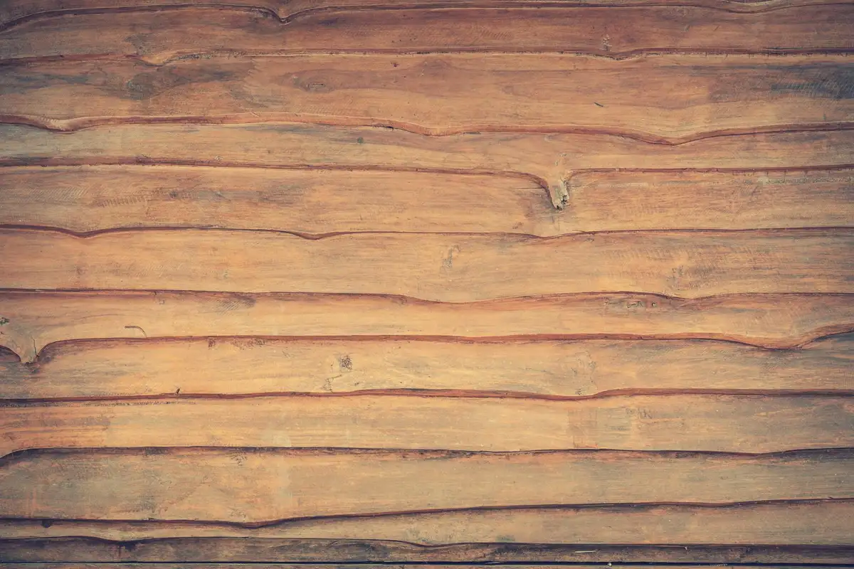 Close-up of wooden planks with prominent grain patterns, representing cedar and redwood considerations for outdoor durability