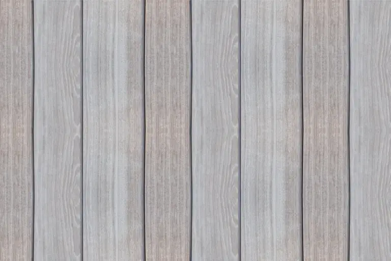 Weathered vertical wooden planks in gray-brown tones, similar to ipe wood