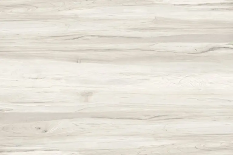 Close-up of a light-colored wooden surface with subtle grain patterns.