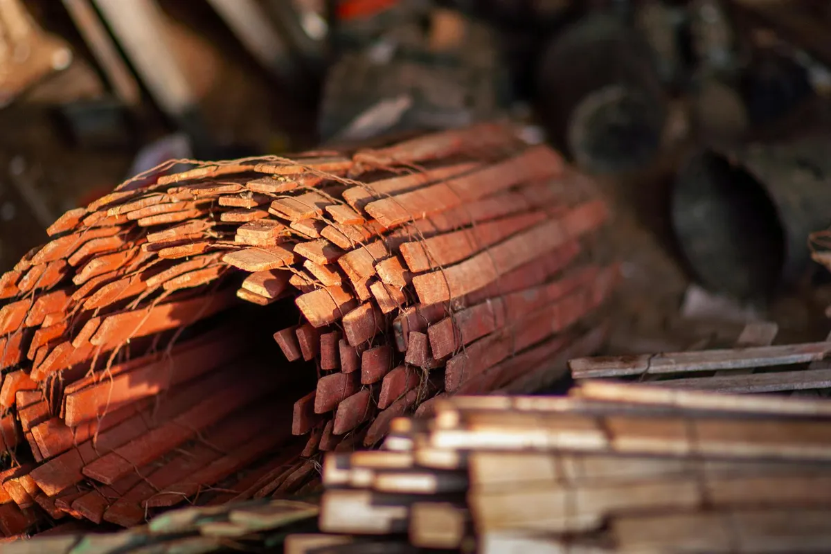 Stack of rough-cut wooden boards arranged in a workshop, ready for milling