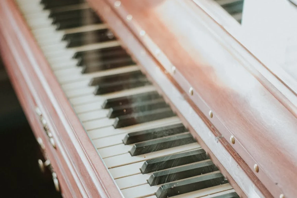 Close-up of a mahogany piano frame with the wood grain visible around glossy piano keys