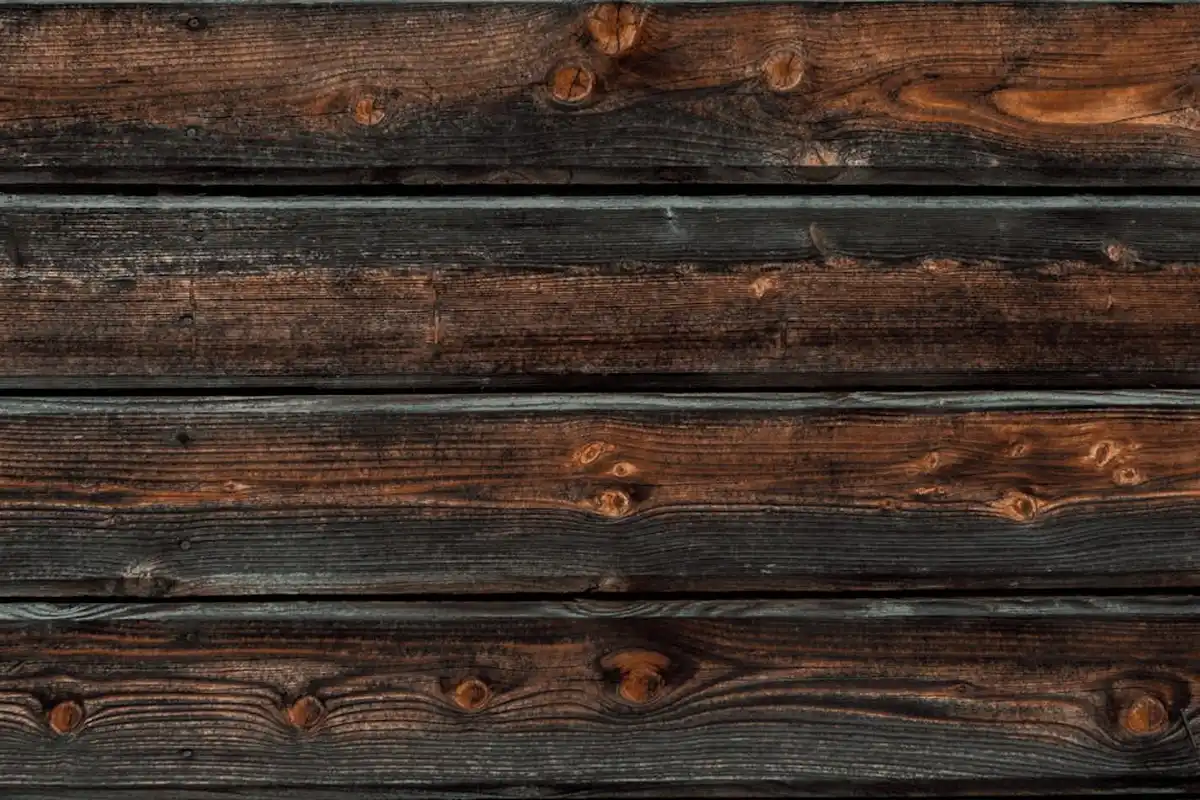 Dark knotty pine boards close up
