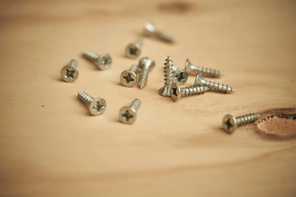 How Do You Safely Remove a Stripped Wood Screw Without Damaging the Grain or Structure?