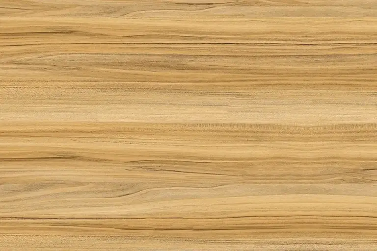 Close-up of a smooth, striped wooden surface with warm golden-brown tones, typical of teak and other oily exotic woods