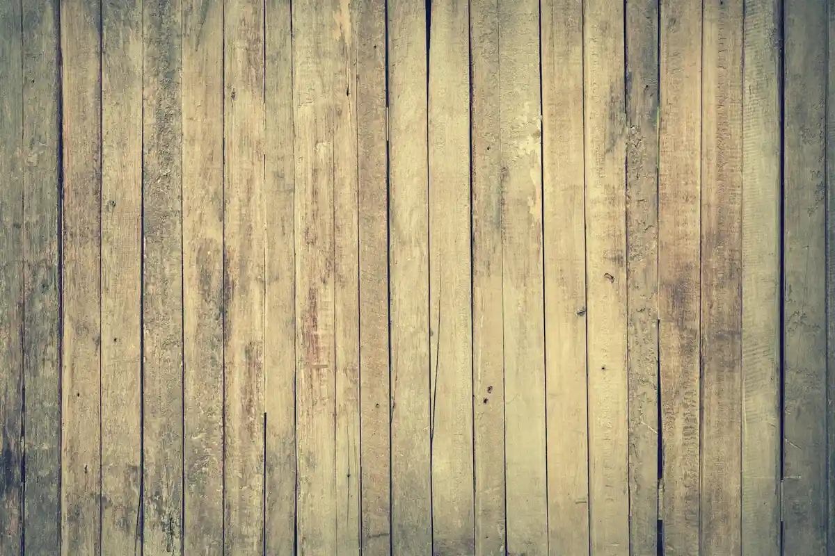 Weathered vertical wooden planks forming a sturdy surface.