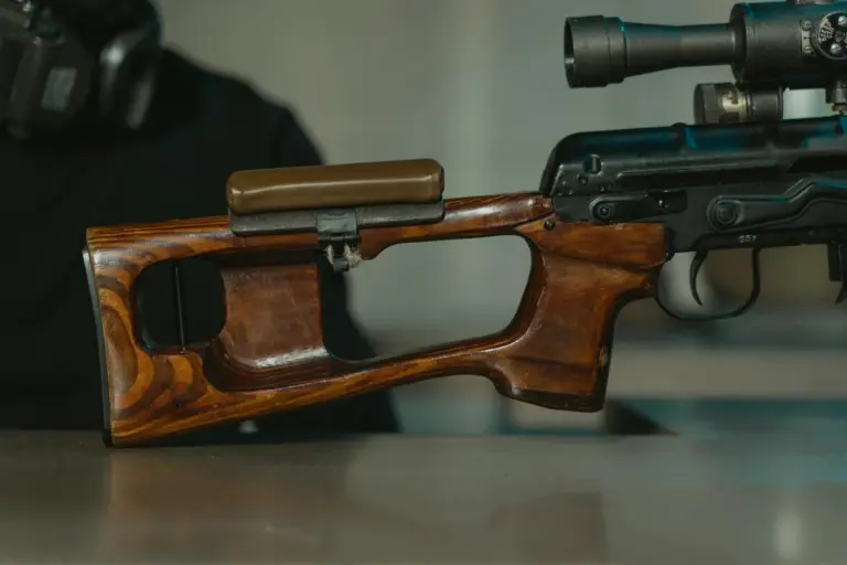 Walnut wood rifle stock with a mounted scope on a workbench