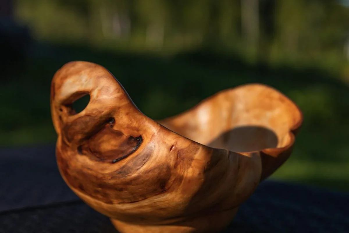 Close-up of a handcrafted wooden bowl with rich grain and warm amber tones