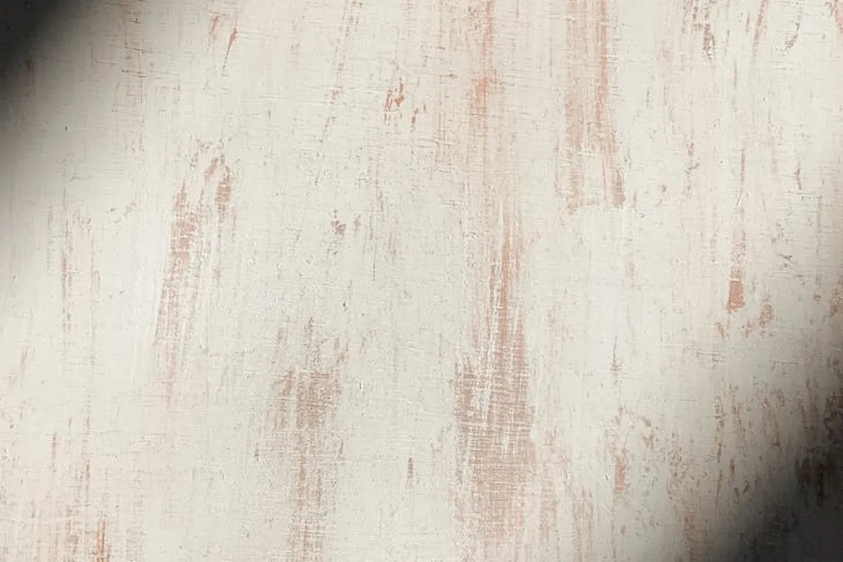 Close-up of a light wood surface with blotchy, uneven stain suggesting a sticky or incomplete drying.