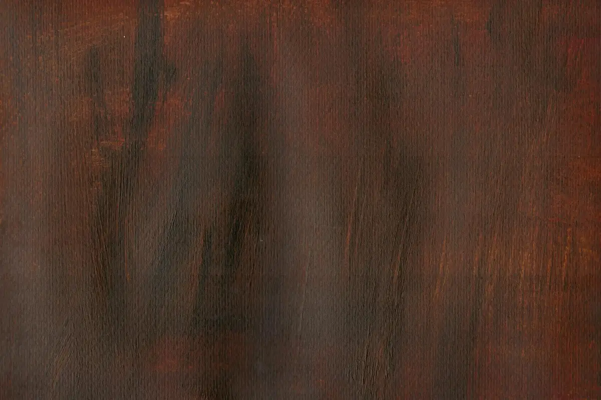 Close-up of dark stained wood grain showing varying absorption and grain patterns