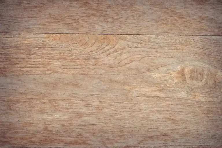 Close-up view of light to medium brown hardwood planks with visible grain patterns