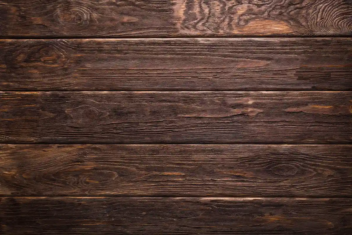 Close-up of dark, textured wooden boards with visible grain patterns
