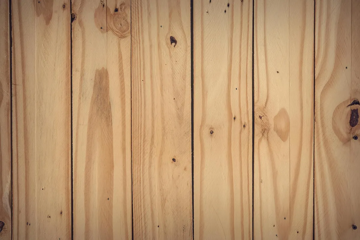 Close-up of vertical wooden floor planks with visible grain and knots.