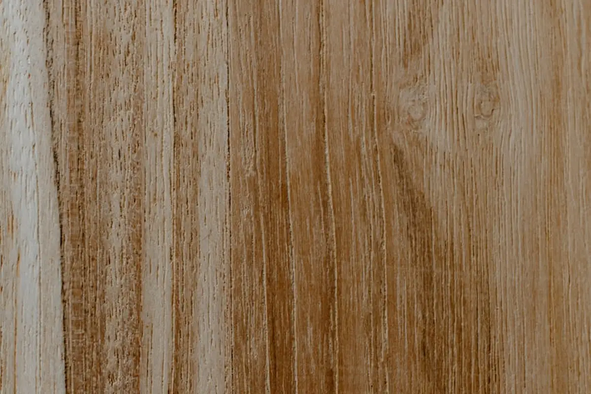 Close-up of vertical wooden boards with natural oil finish, showing grain patterns and color variation.