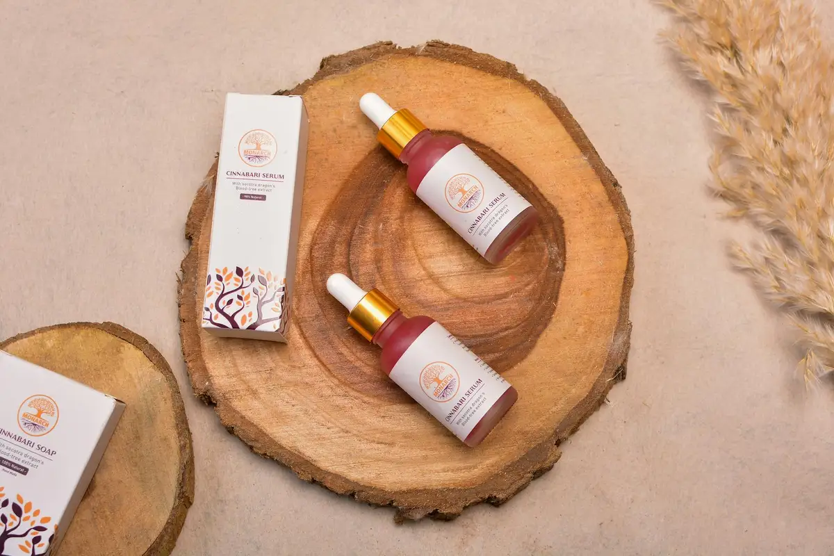 Bottles of penetrating wood oil with their packaging displayed on wooden slab sections in a workshop-like setting.