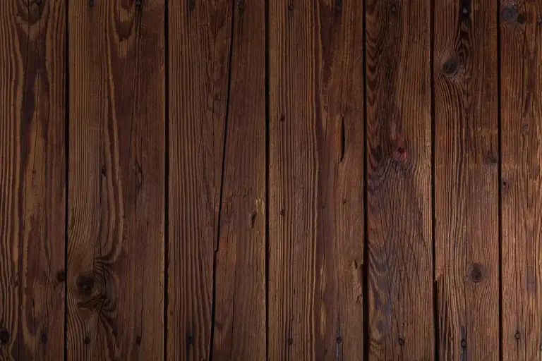Close-up of dark brown wooden planks with visible knots and grain patterns