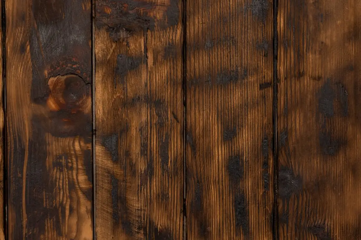 Close-up of dark-stained wooden planks showing grain and knots