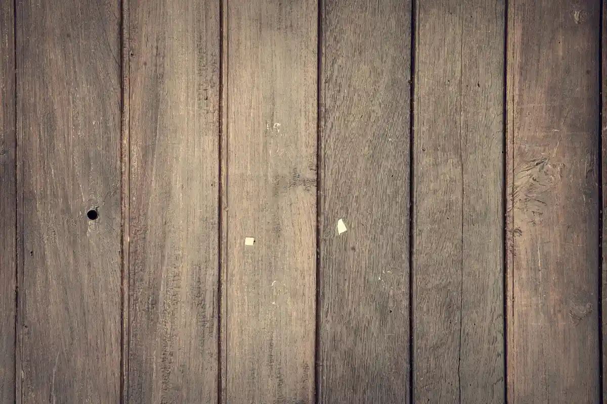 Close-up of wooden boards showing grain and density variations, illustrating the cellular structure that contributes to termite resistance.