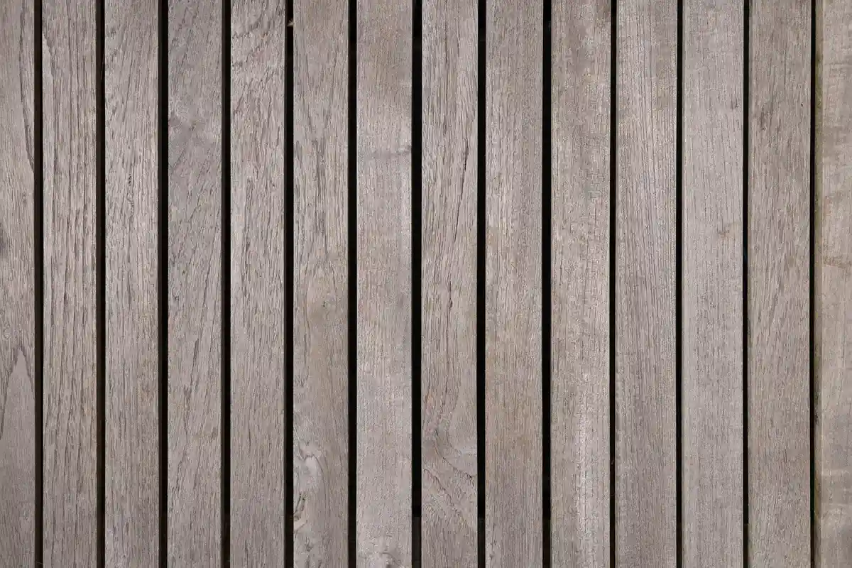Vertical weathered wooden boards arranged as a prep surface for cleaning and preparing wood before finishing.