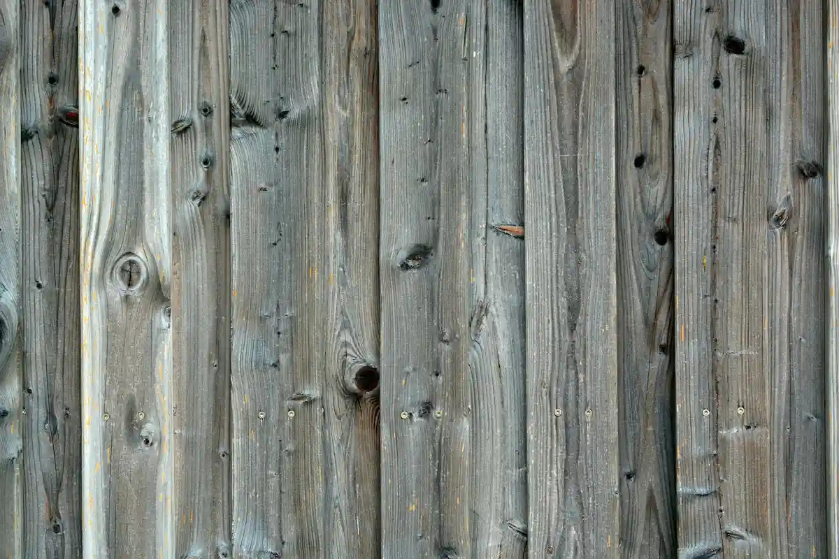 Weathered vertical wooden boards with visible grain and knots