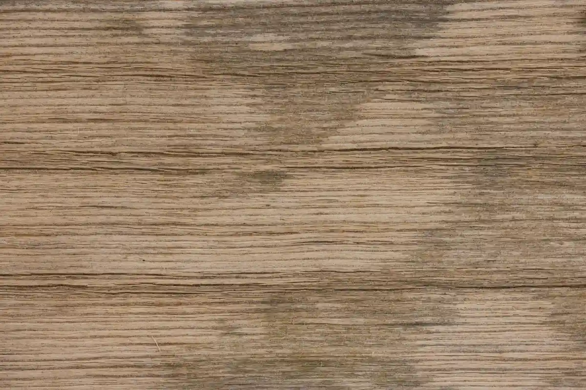 Wooden surface with visible iron and tannin stains.
