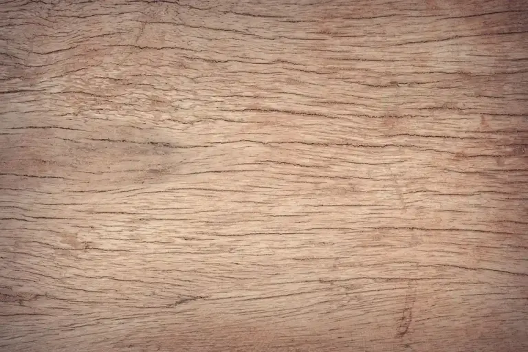 Close-up of a wooden surface with warm brown tones and visible grain patterns.