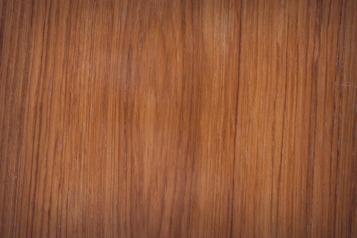 Close-up of a warm wood grain surface suitable for citrus oil cleaning and finishing