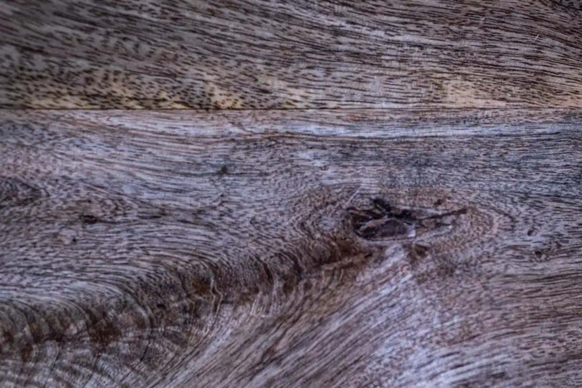 Close-up of a weathered wooden surface showing prominent grain patterns.