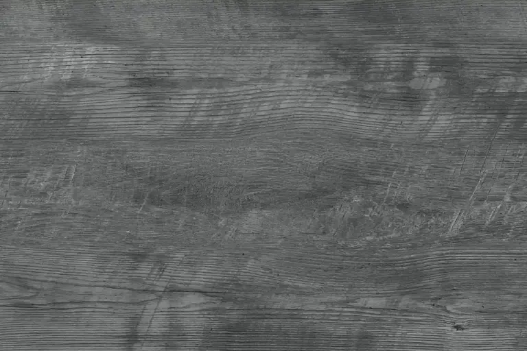 Close-up of textured gray wood grain surface, displaying natural patterns suitable as a backdrop for a wood stain guide.