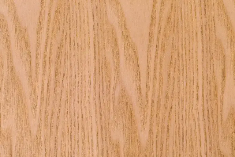 Close-up of pale wood grain with tight, vertical patterns and natural texture.