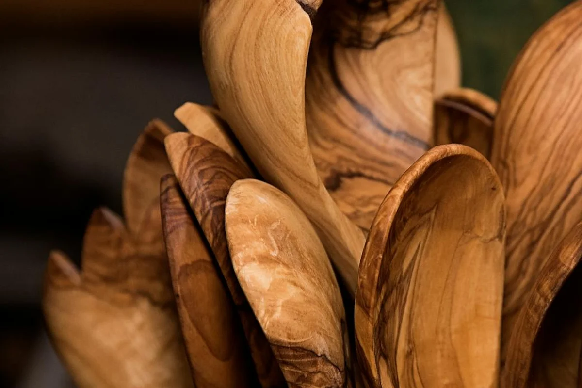 Close-up of stacked wooden spoons showing natural grain patterns.