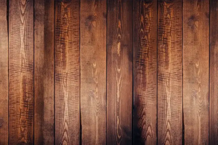 Close-up of vertical wooden planks with rich brown grain patterns.