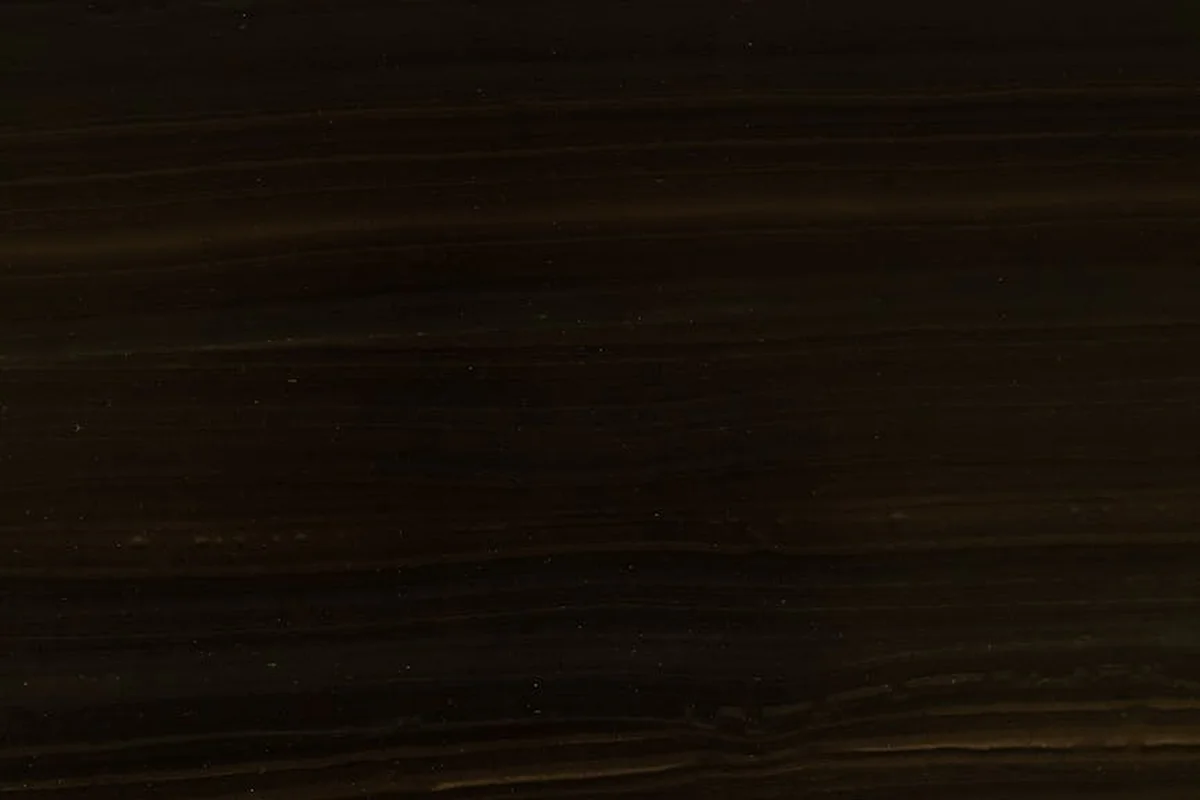 Close-up of dark wood veneer with rich, horizontal grain patterns and subtle highlights.